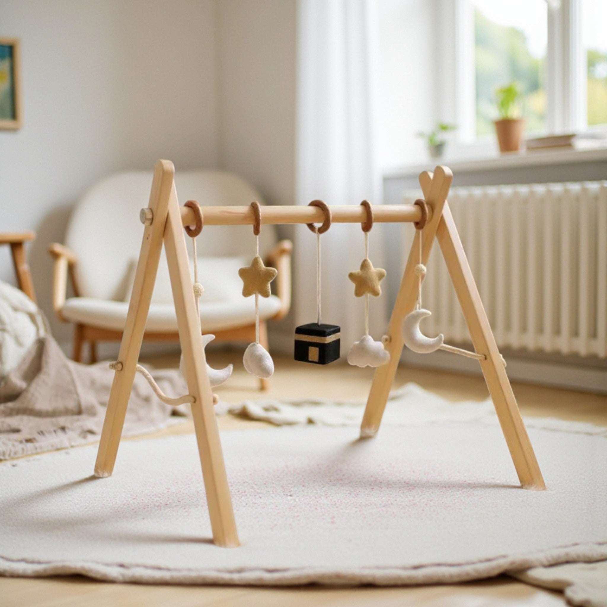 Wooden baby play arch with hanging toys and Islamic symbols, natural wood and soft felt, an ideal new baby gift
